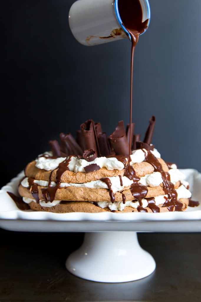 pouring ganache onto a Chocolate Pavlova Cake