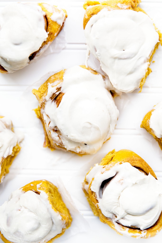 Soft, pillowy pumpkin cinnamon rolls topped with a tangy cream cheese frosting. Perfect for a weekend breakfast! | via Broma Bakery | #stickybuns
