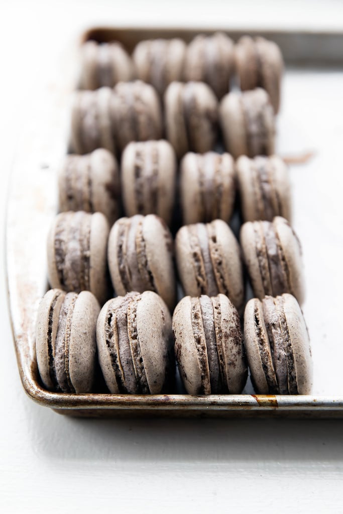 cookies and cream macarons on a baking tray