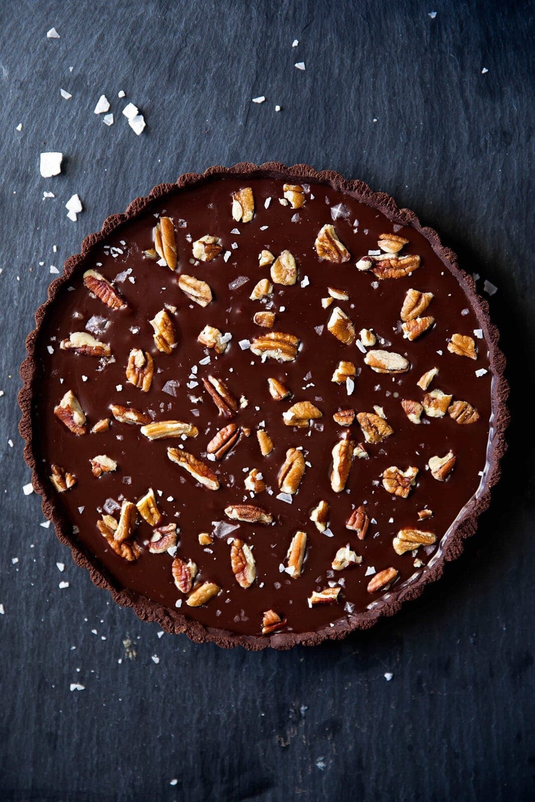 Salted Caramel Chocolate Tart has a chocolate pretzel crust, salted caramel center, and is topped with melted chocolate, pecans, and sea salt. Uhm, swoon?!