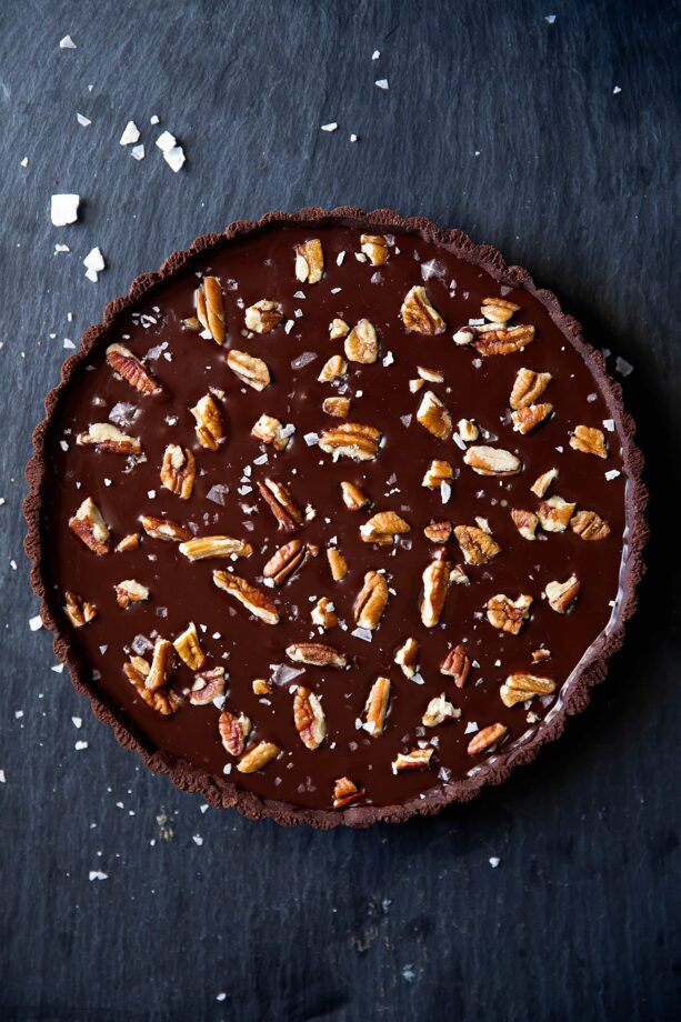 Salted Caramel Chocolate Tart has a chocolate pretzel crust, salted caramel center, and is topped with melted chocolate, pecans, and sea salt. Uhm, swoon?!