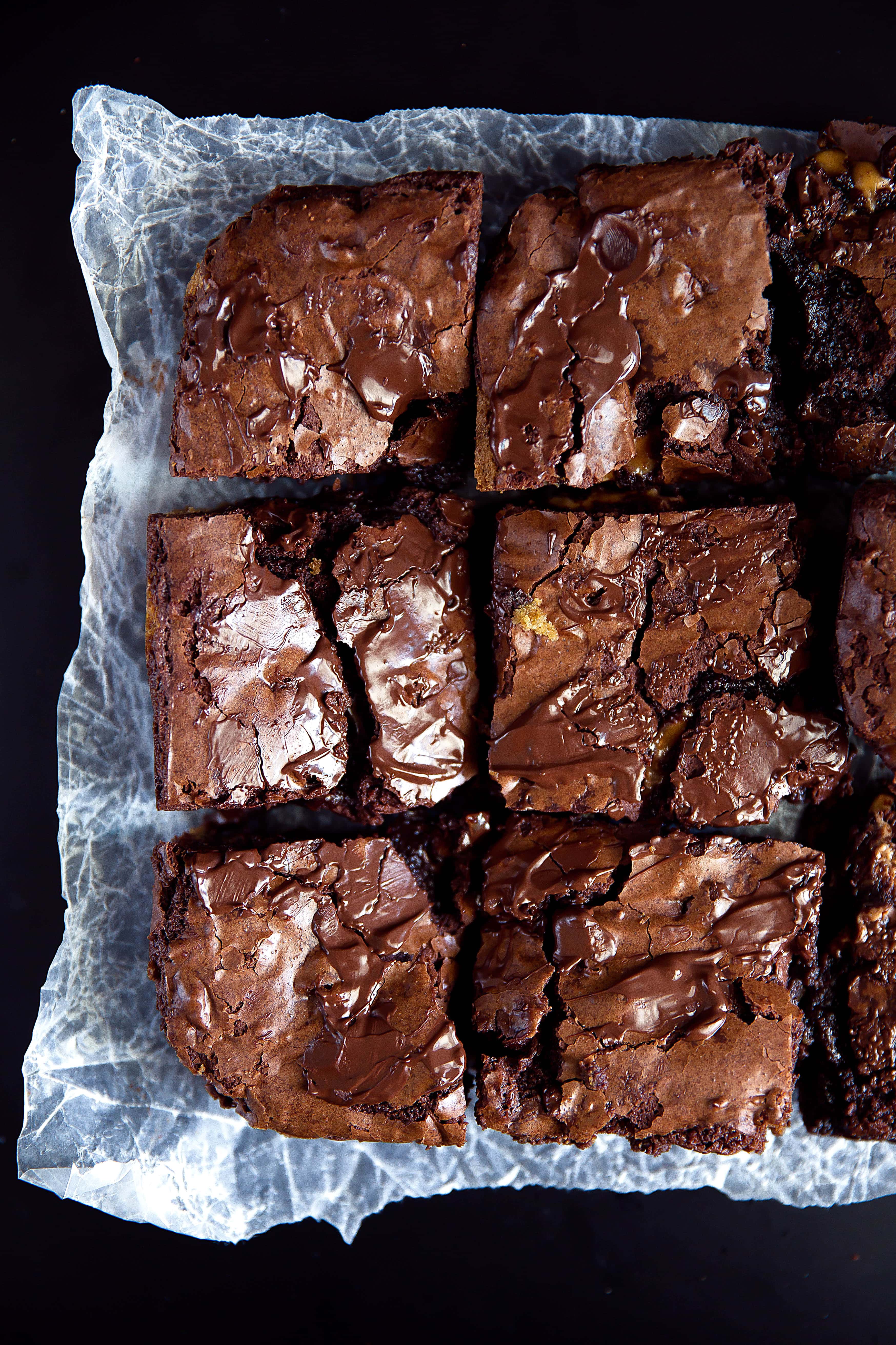 sliced chocolate chip cookie brownies on parchment paper