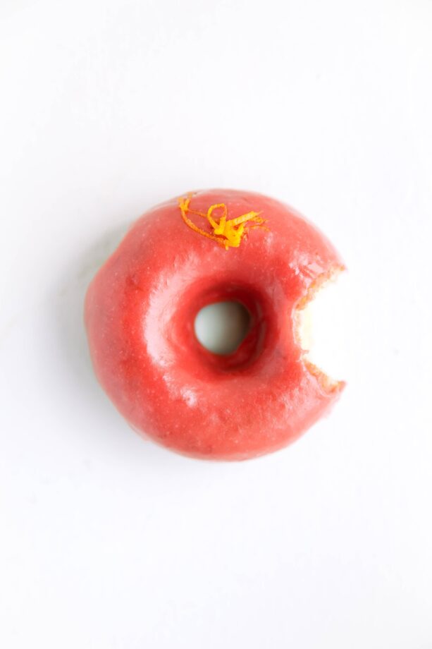 Baked Rhubarb Orange Glazed Donuts: soft and fluffy rhubarb donuts flavored with orange and dipped in a tangy rhubarb glaze!