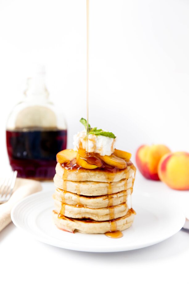 Bourbon Peach Pancakes topped with bourbon-soaked peaches make for the perfect weekend breakfast!