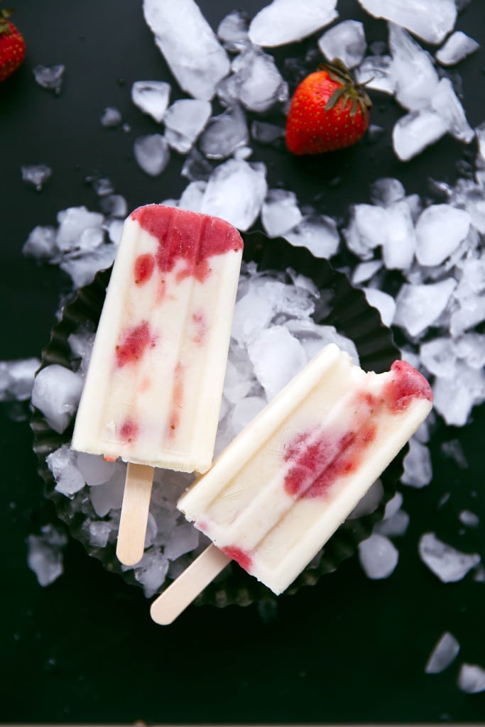 Skinny Strawberries and Cream Popsicles: layers of roasted strawberries and greek yogurt make these popsicles a bikini-welcome summer treat!