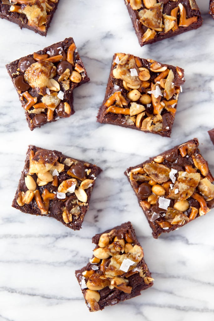 When you're hungry, The Munchies Brownies got you covered: fudgy brownies topped with a sweet and salty combination of pretzels, peanuts, chocolate, potato chips, and sea salt!