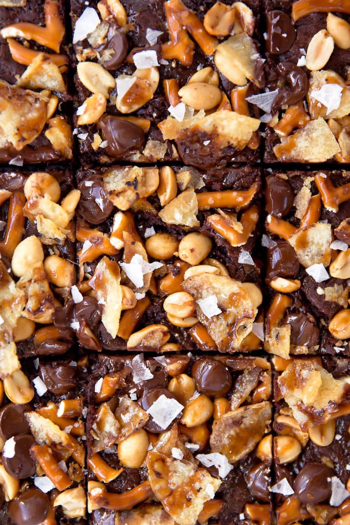 When you're hungry, The Munchies Brownies got you covered: fudgy brownies topped with a sweet and salty combination of pretzels, peanuts, chocolate, potato chips, and sea salt!