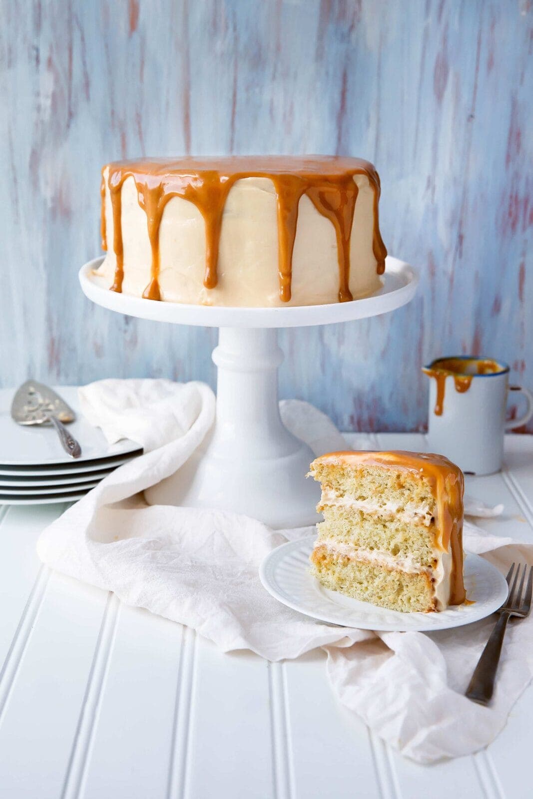 A fragrant banana layer cake made with homemade dulce de leche frosting!