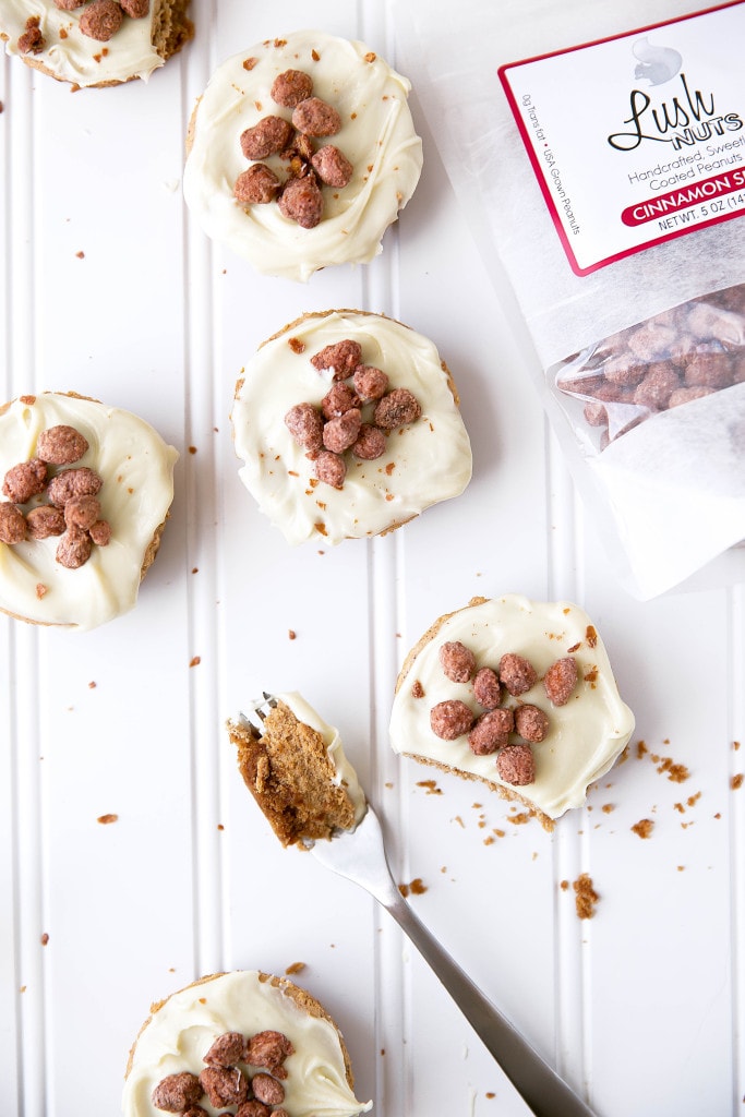 Mini pumpkin spice cheesecakes topped with a white chocolate ganache and cinnamon candied peanuts!