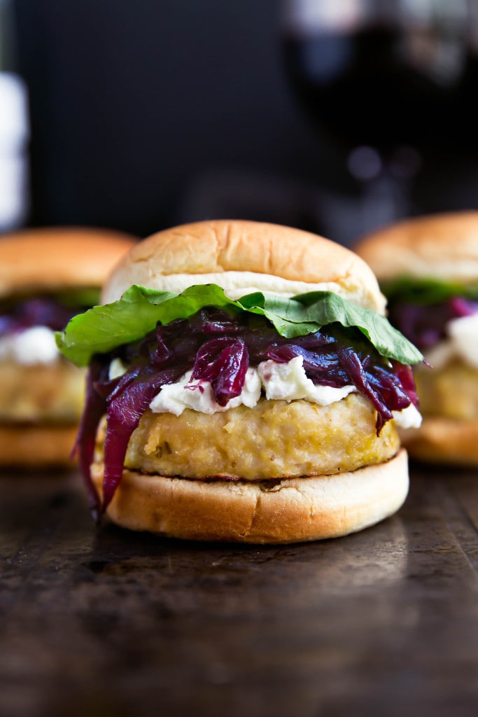 Say hello to these classy game-day buns: rosemary-infused turkey sliders topped with red wine caramelized onions, crumbled goat cheese, and arugula!