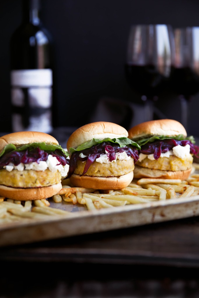 Say hello to these classy game-day buns: rosemary-infused turkey sliders topped with red wine caramelized onions, crumbled goat cheese, and arugula!