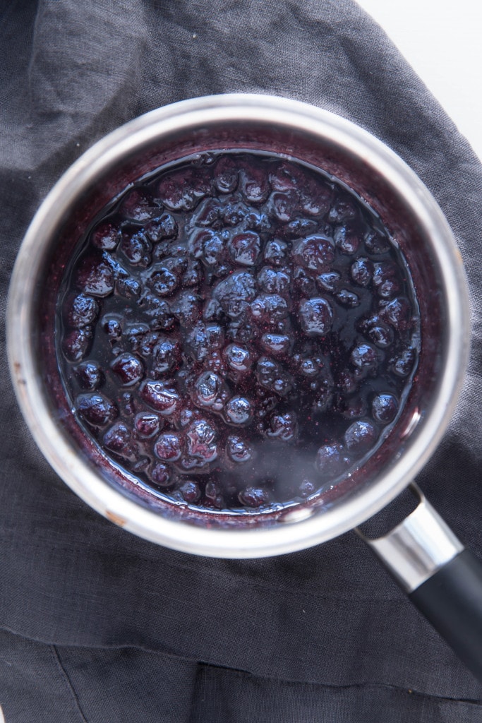 Oven roasted brussels sprouts with a blueberry balsamic glaze tossed with bacon and blue cheese makes for a delectable addition to your holiday table!