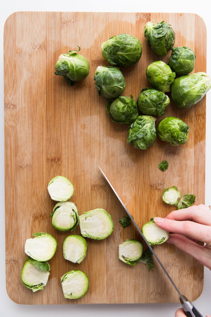 Oven roasted brussels sprouts with a blueberry balsamic glaze tossed with bacon and blue cheese makes for a delectable addition to your holiday table!