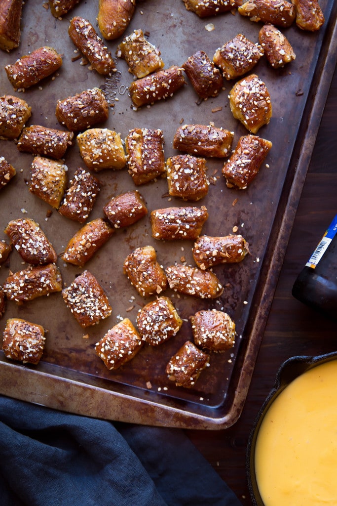 Bring on game day with these homemade pretzel bites topped with everything bagel seasoning, served with beer and cheddar cheese dip!