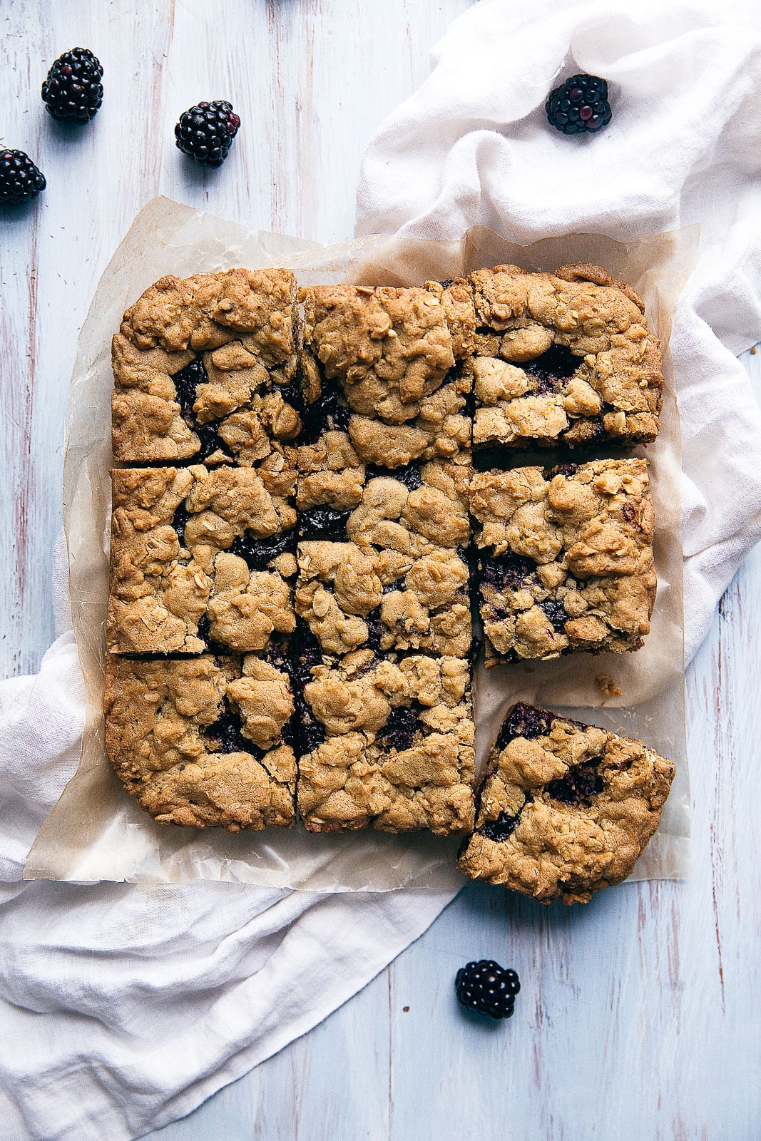 Chewy oatmeal bars with a homemade blackberry jam center and crumble topping