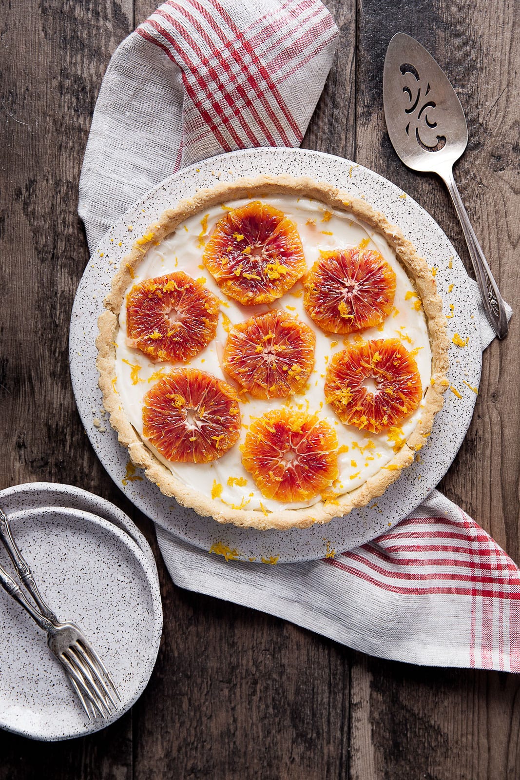 A flakey tart with cream cheese filling and topped with candied ginger blood oranges