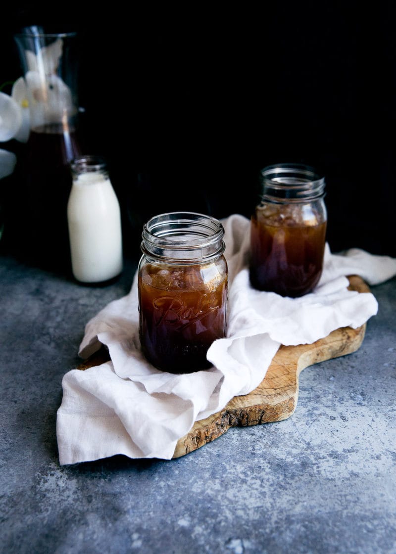 two glasses on homemade cold brew coffee on a board