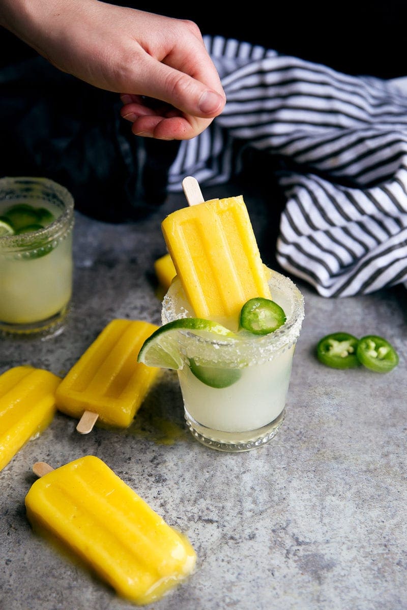 Forget ice cubes, we're dipping Jalapeño Mango Margarita Popsicles into our drinks! Perfect for Cinco de Mayo!