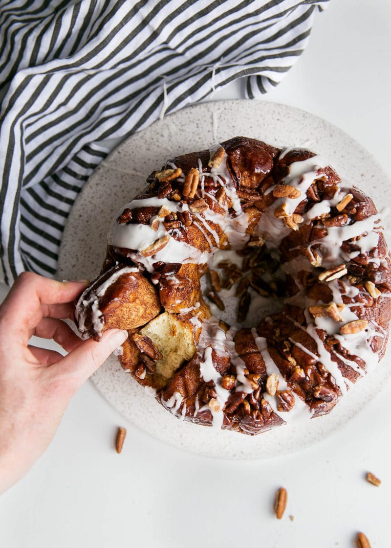 A soft and pillowy buttered rum monkey bread covered in cinnamon sugar, pecans, and topped with rum icing. So, like, can I have this every weekend?