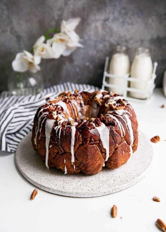 A soft and pillowy buttered rum monkey bread covered in cinnamon sugar, pecans, and topped with rum icing. So, like, can I have this every weekend?
