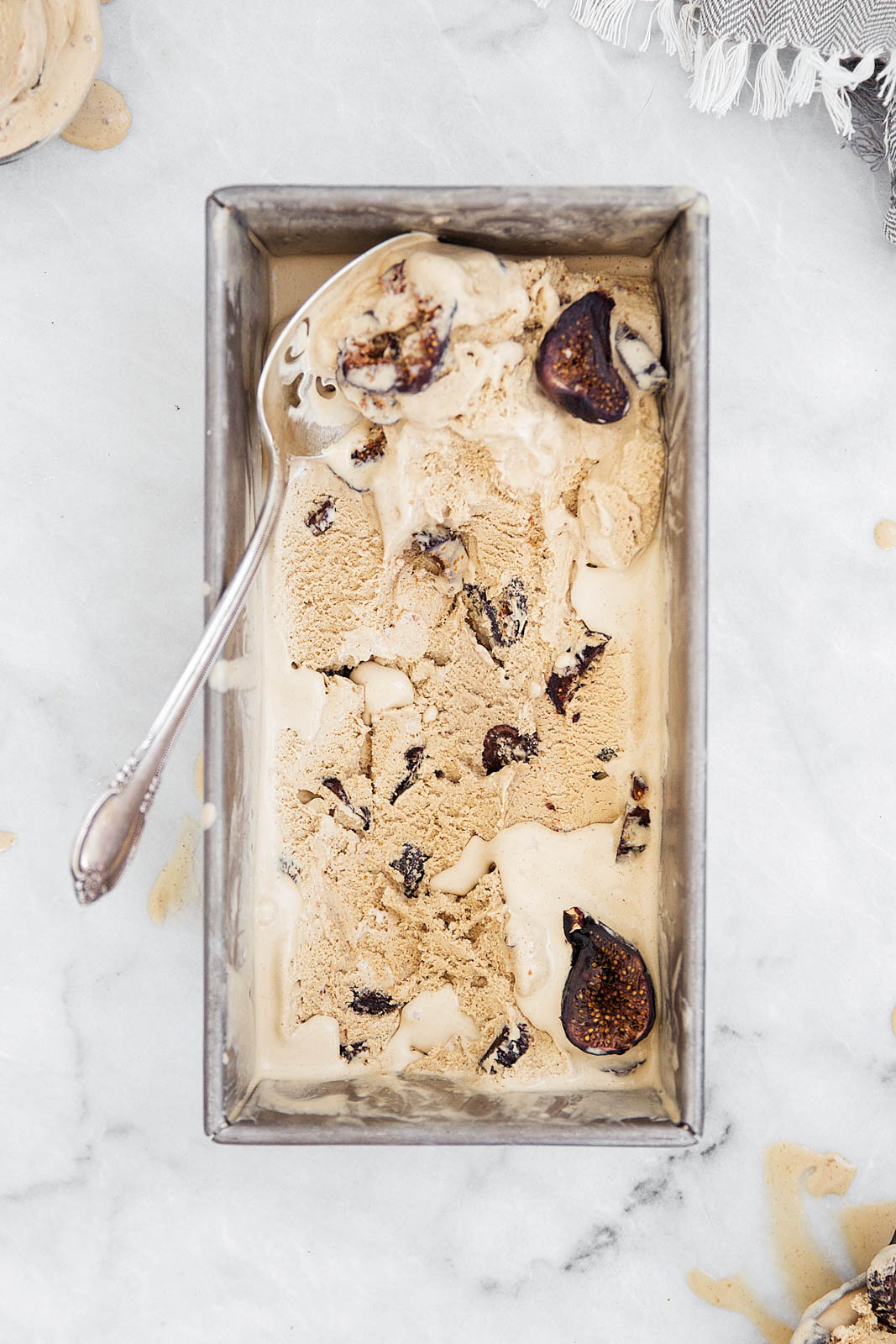 coffee ice cream in a loaf pan with a spoon