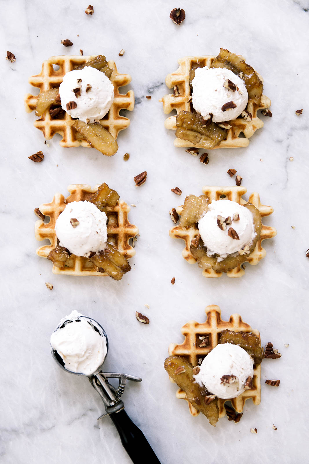 Bananas Foster Waffles made with vanilla ice cream, pecans, and caramelized rum bananas over a pillowy banana rum waffle. Yahm.