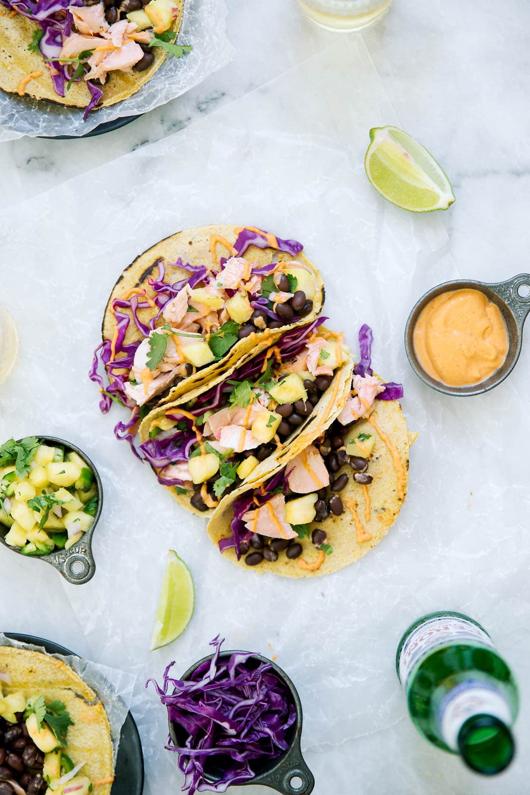 Coconut Salmon Tacos marinaded in coconut milk, lime, and ginger, complete with a homemade jalapeño pineapple salsa & sriracha mayo. A total hit for your next Taco Tuesday.