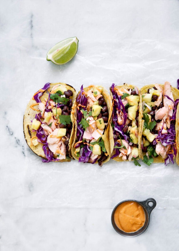 Coconut Salmon Tacos marinaded in coconut milk, lime, and ginger, complete with a homemade jalapeño pineapple salsa & sriracha mayo. A total hit for your next Taco Tuesday.