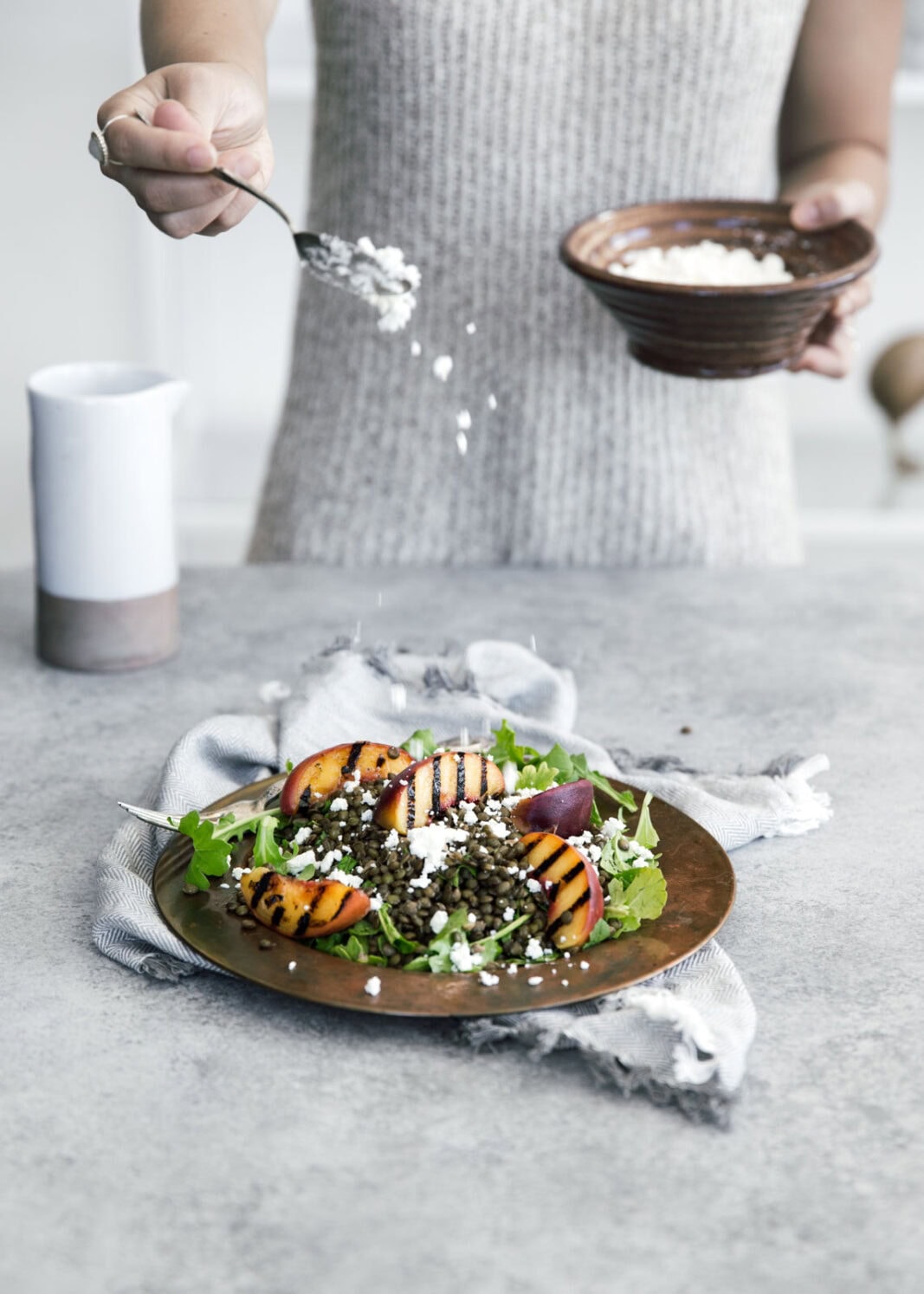 Take advantage of peach season with this green lentil salad with char-grilled peaches, goat cheese, and rosé vinaigrette.