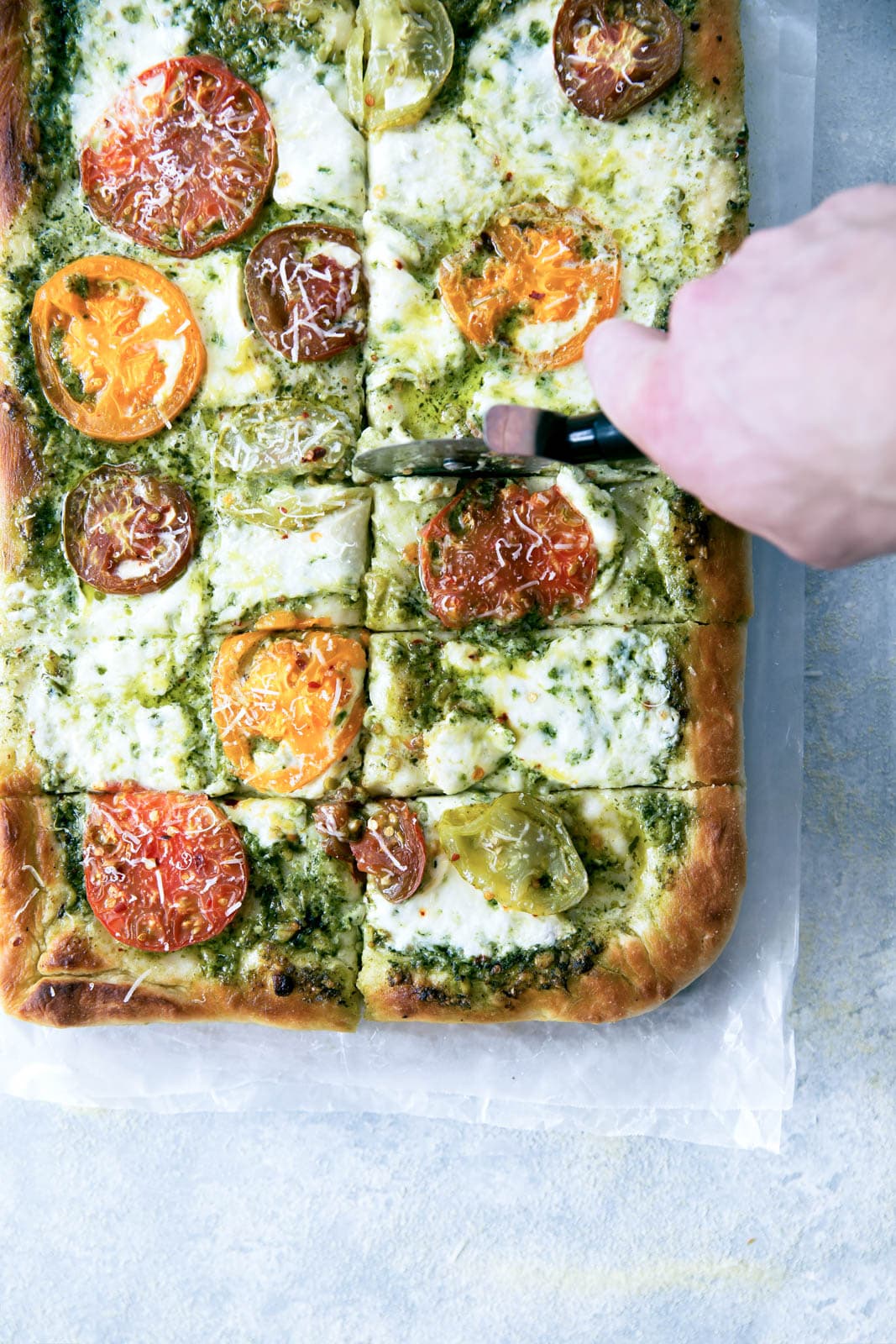 Say goodbye to heirloom tomato season with this ridiculously addicting heirloom tomato pesto pan pizza!