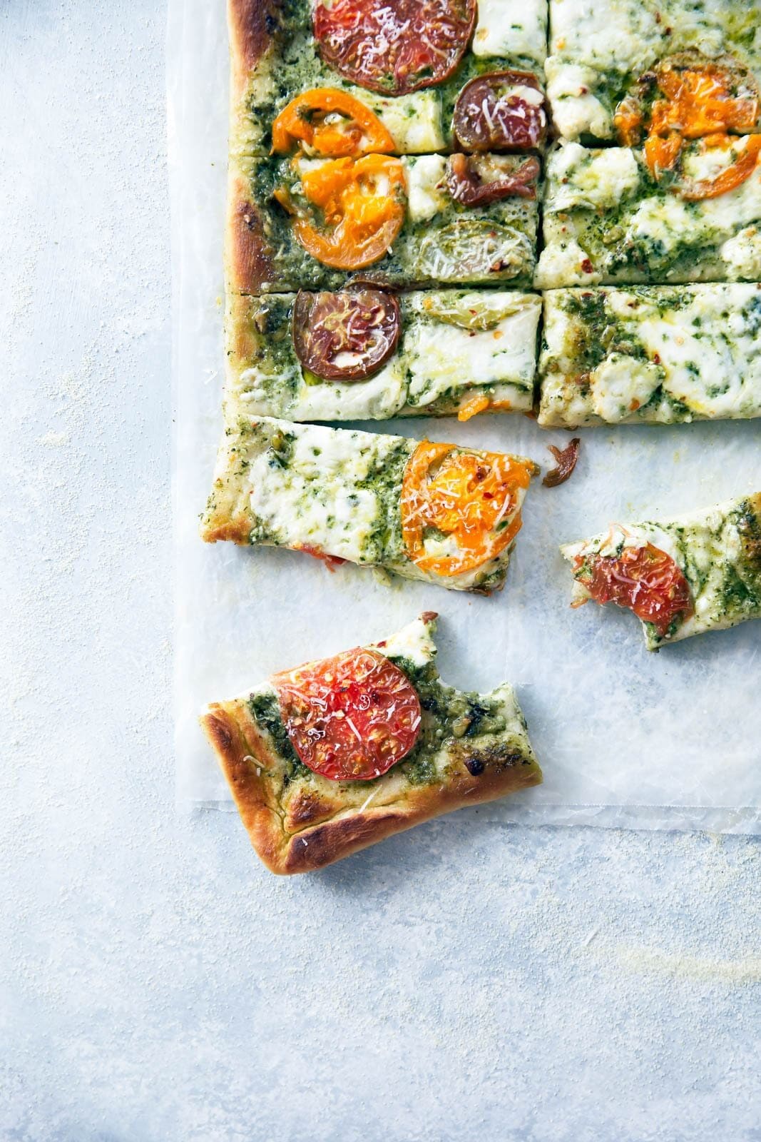 Say goodbye to heirloom tomato season with this ridiculously addicting heirloom tomato pesto pan pizza!