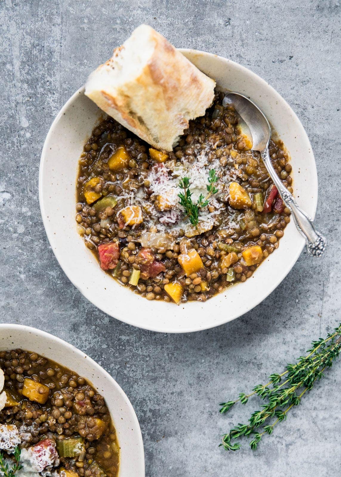 bowl of butternut squash lentil stew topped with cheese