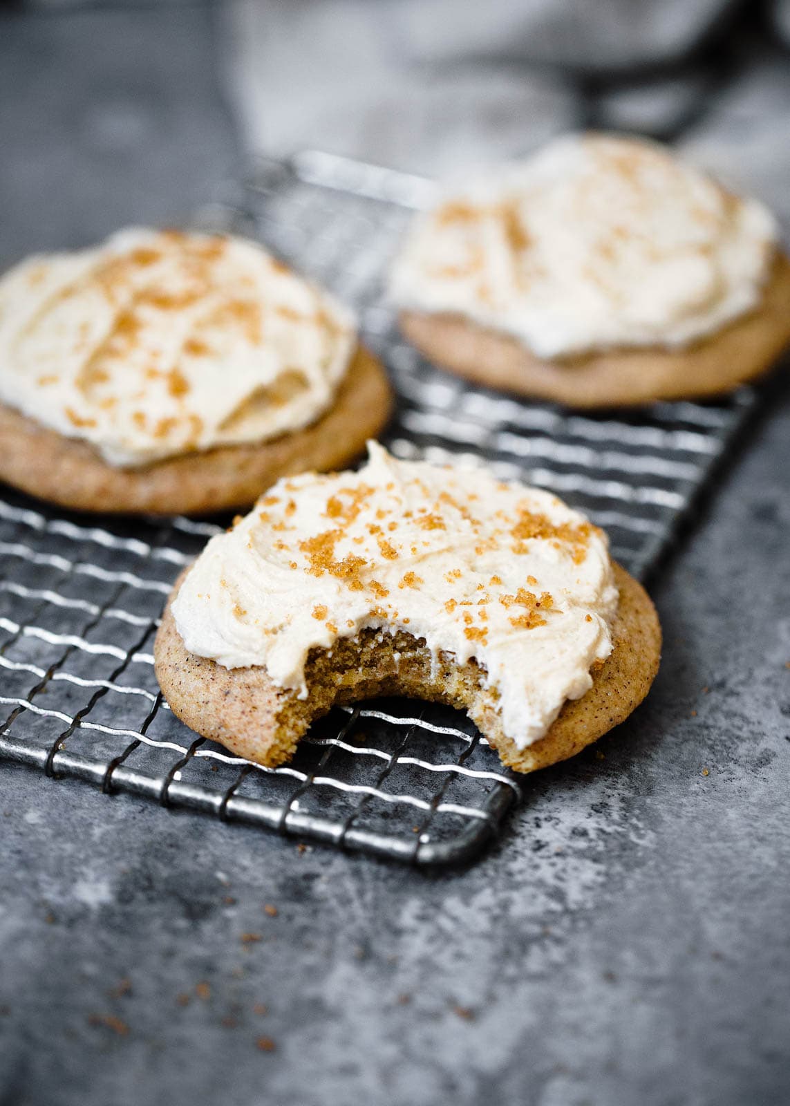 frosted brown butter snickerdoodles with a bite taken out