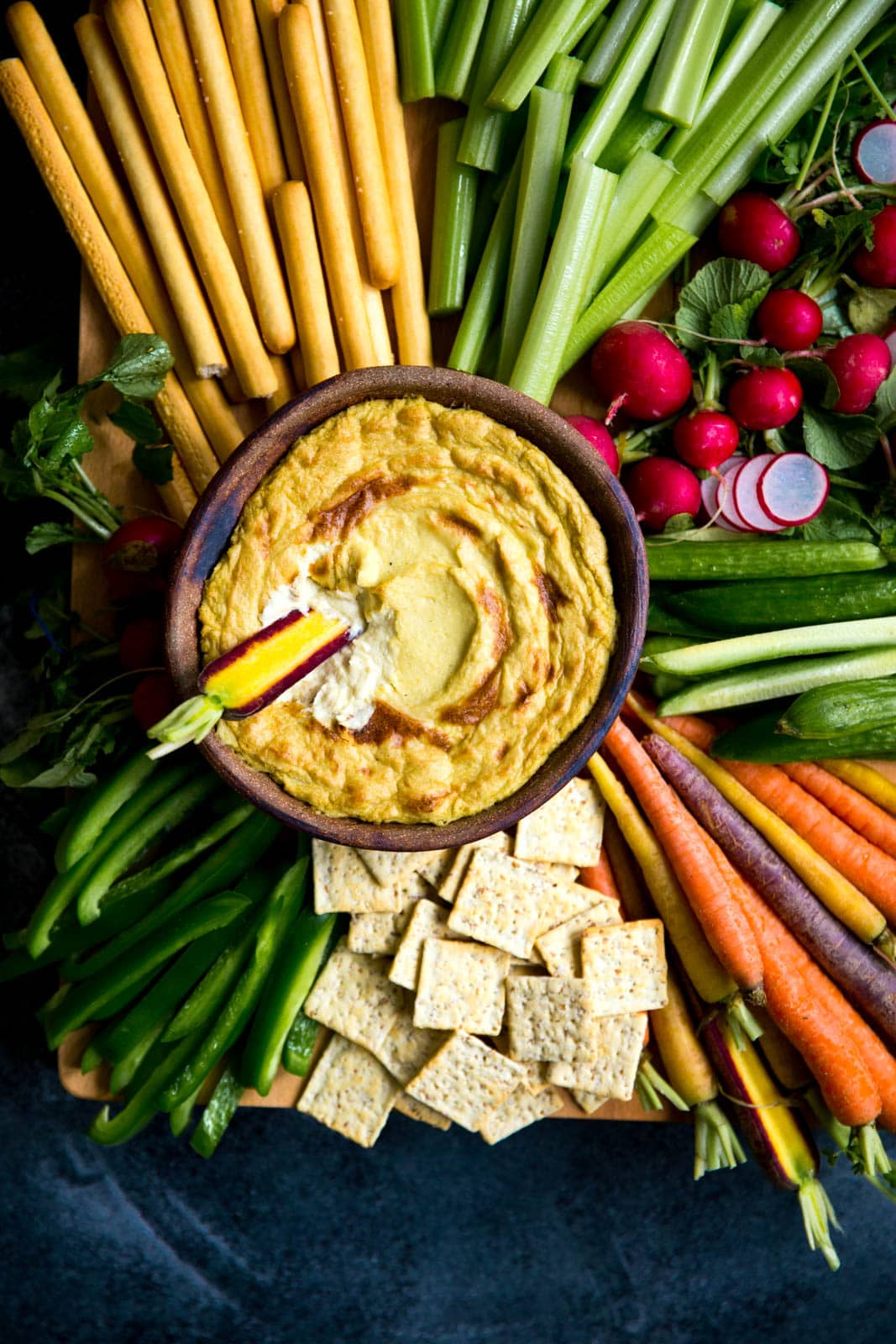 Mom's creamy, cheesy Artichoke Dip with a bountiful crudités is perfect for a crowd.