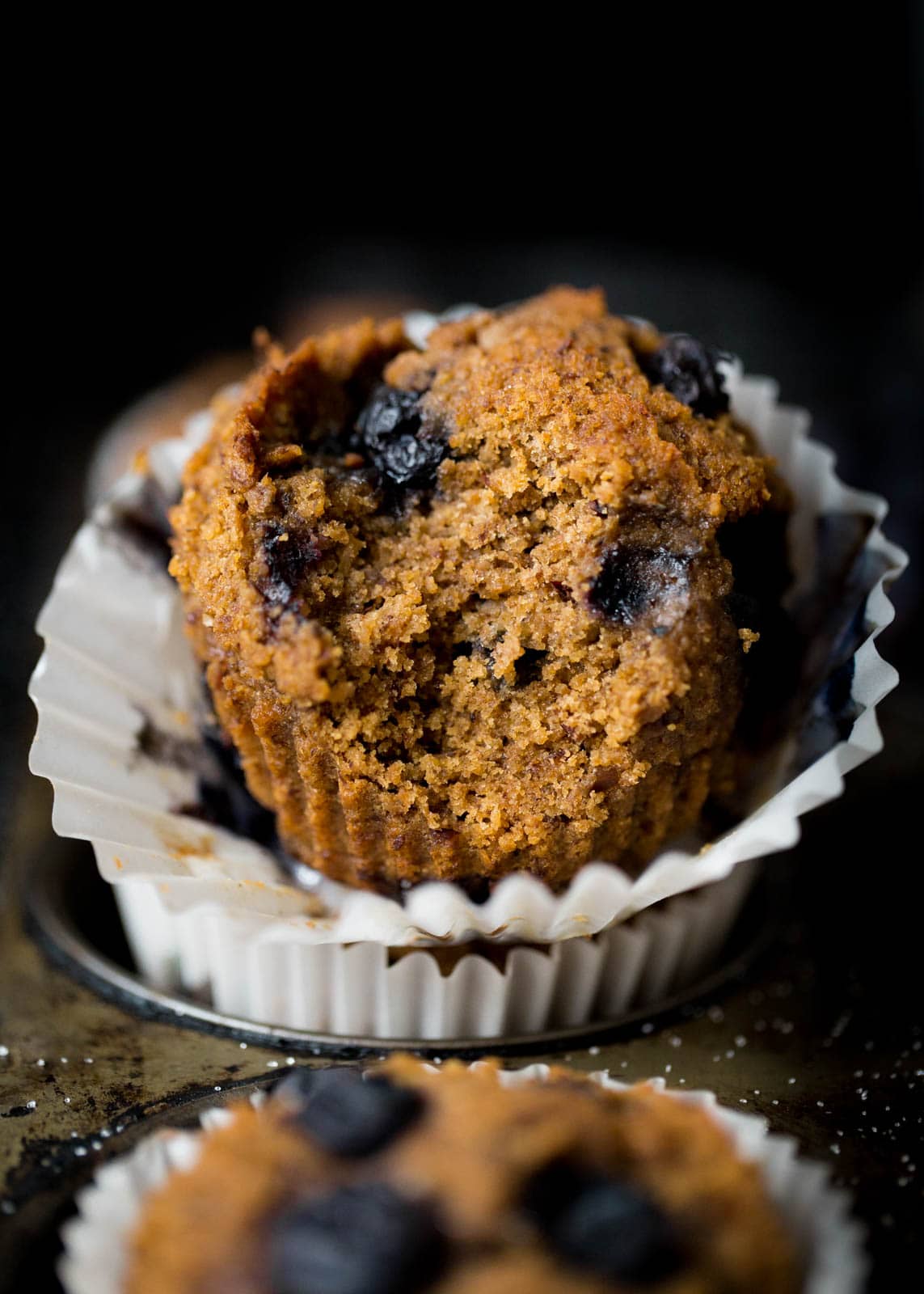 blueberry bran muffin with bite taken out