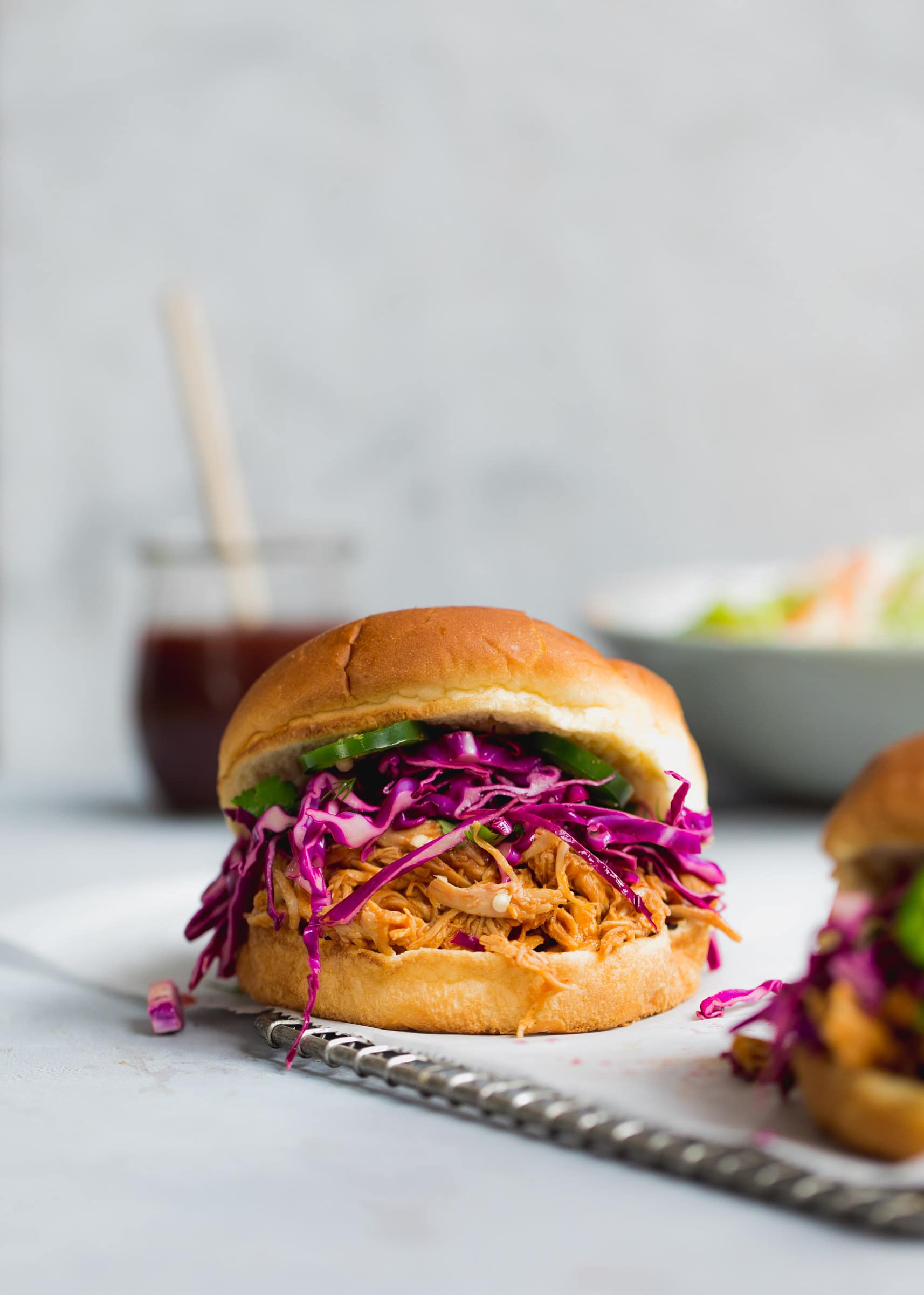 Slow Cooker Asian BBQ Pulled Chicken Sandwich with cilantro and purple cabbage slaw