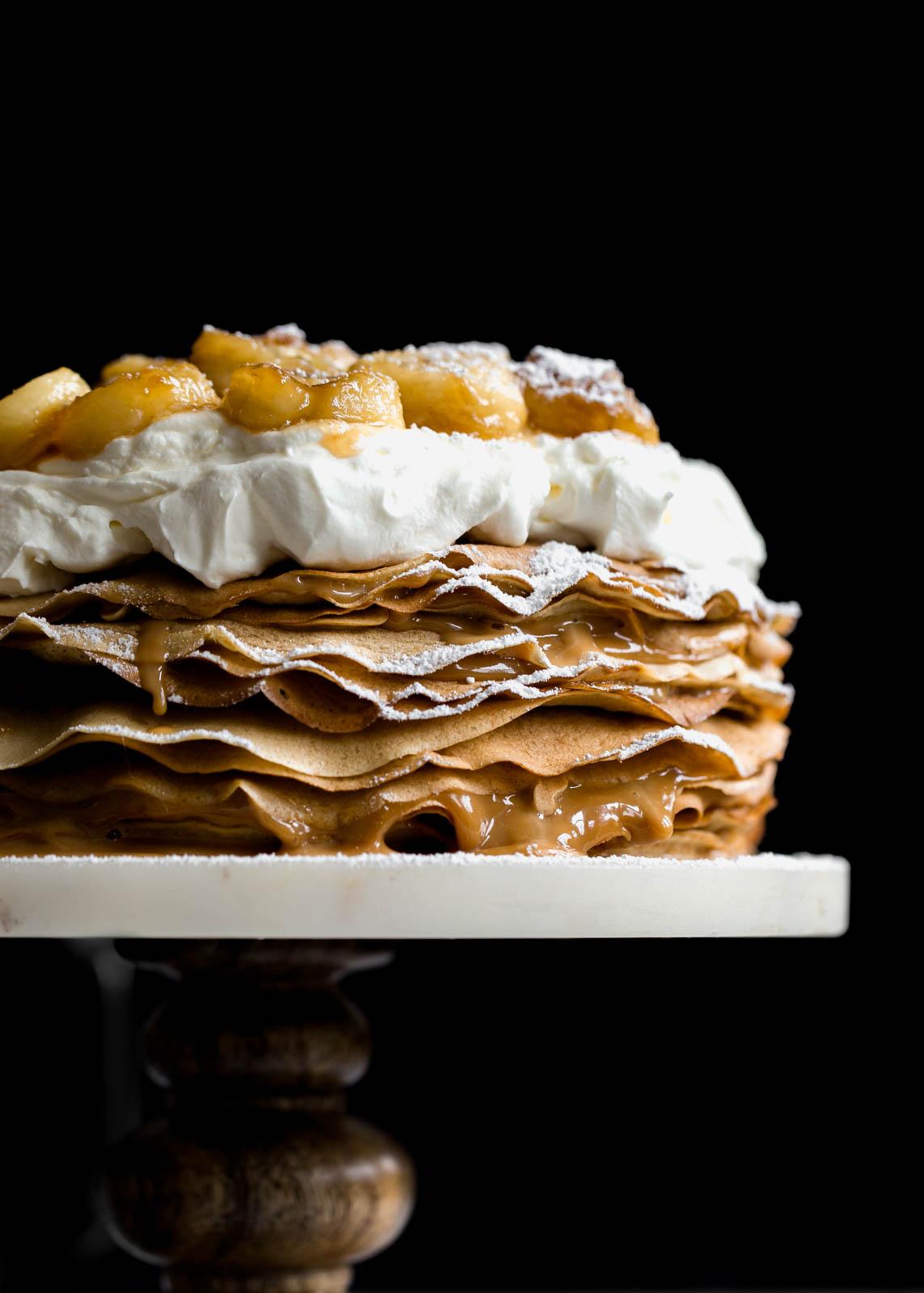 Layer after layer of banana crepes and dulce de leche, topped with whipped cream and bananas foster!