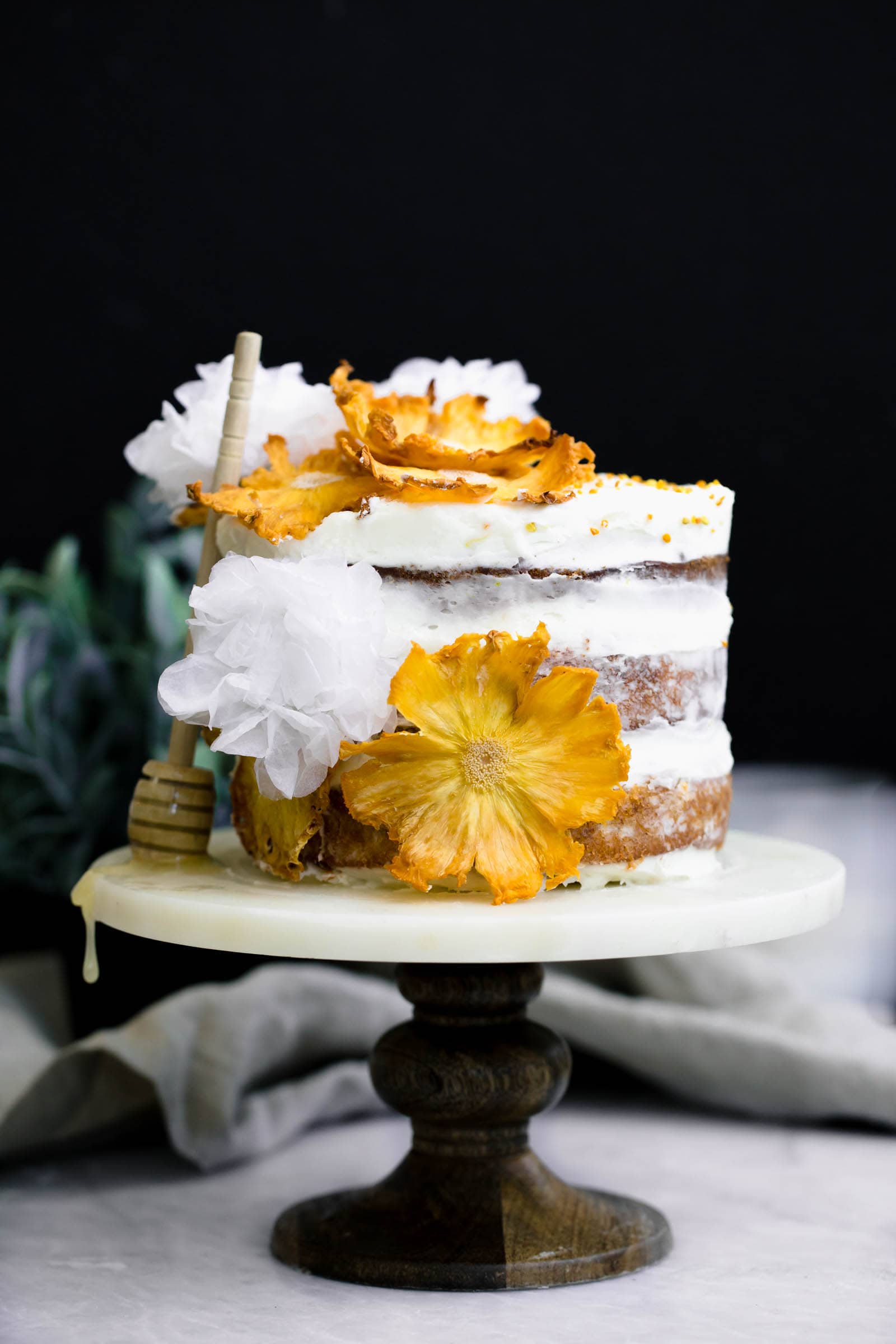 Hummingbird Cake on cake stand with honey