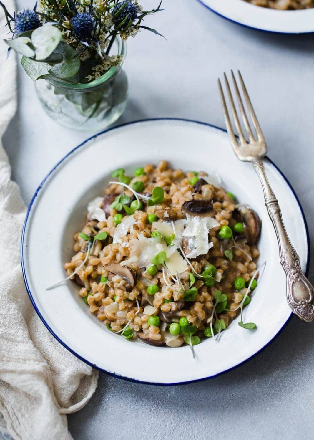 A warm and comforting farro risotto made with fresh spring peas and sautéed mushrooms!