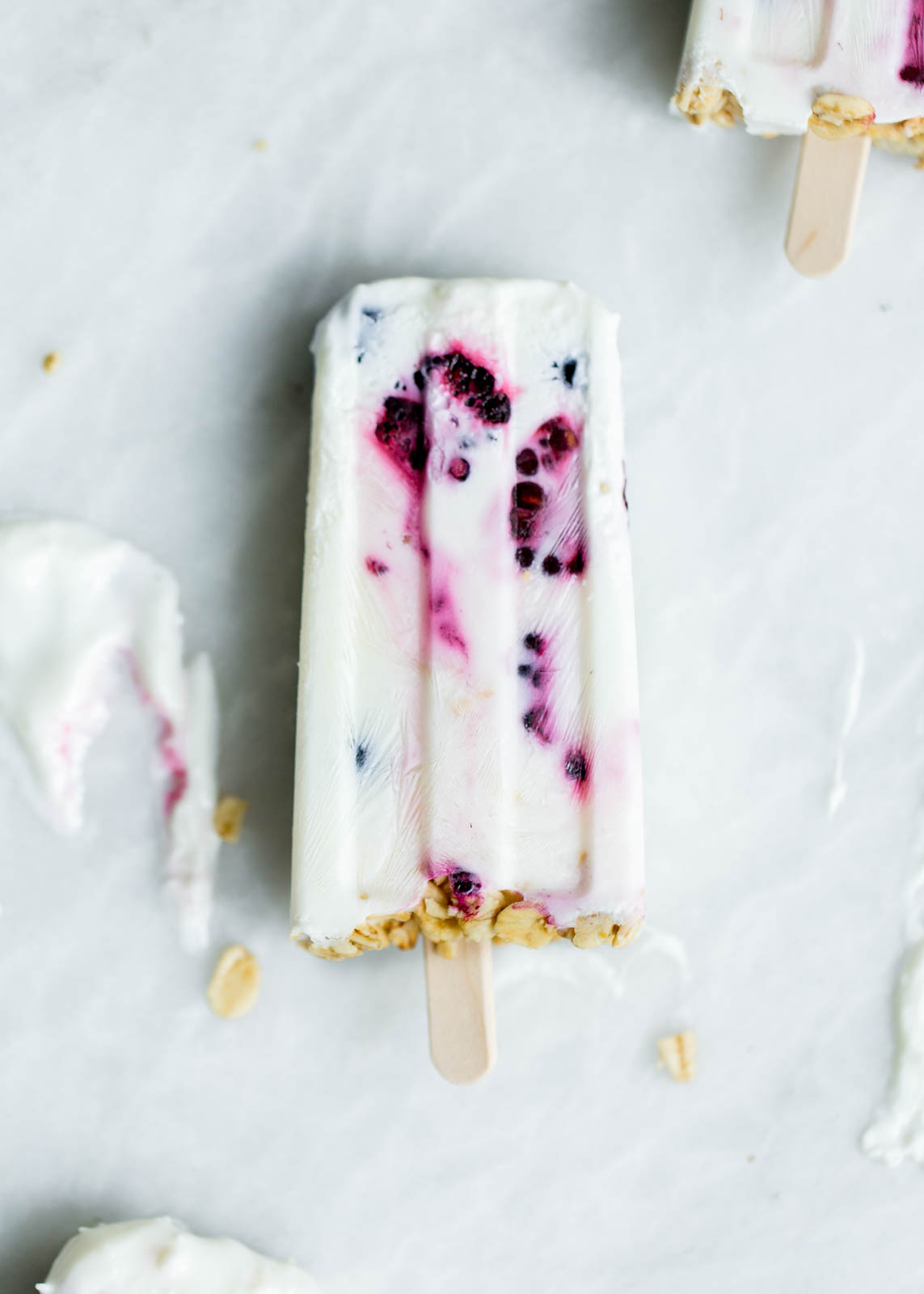 Frozen Coconut Greek Yogurt Breakfast Popsicles with berries and granola. Oh yeah.