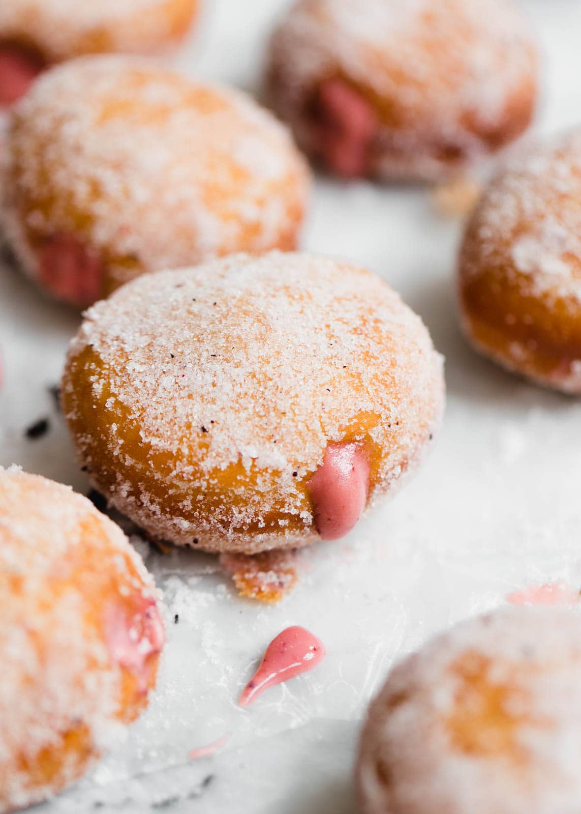 Golden and fried to perfection, these yeasted donuts are tossed in a hibiscus sugar and stuffed with a hibiscus pastry cream. Uhm, DROOL.