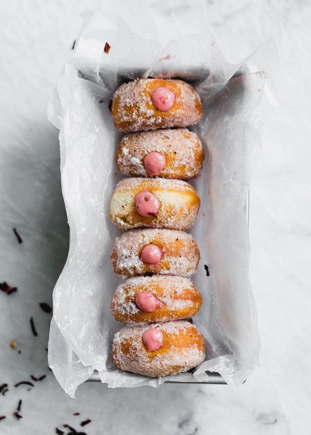 Golden and fried to perfection, these yeasted donuts are tossed in a hibiscus sugar and stuffed with a hibiscus pastry cream. Uhm, DROOL.