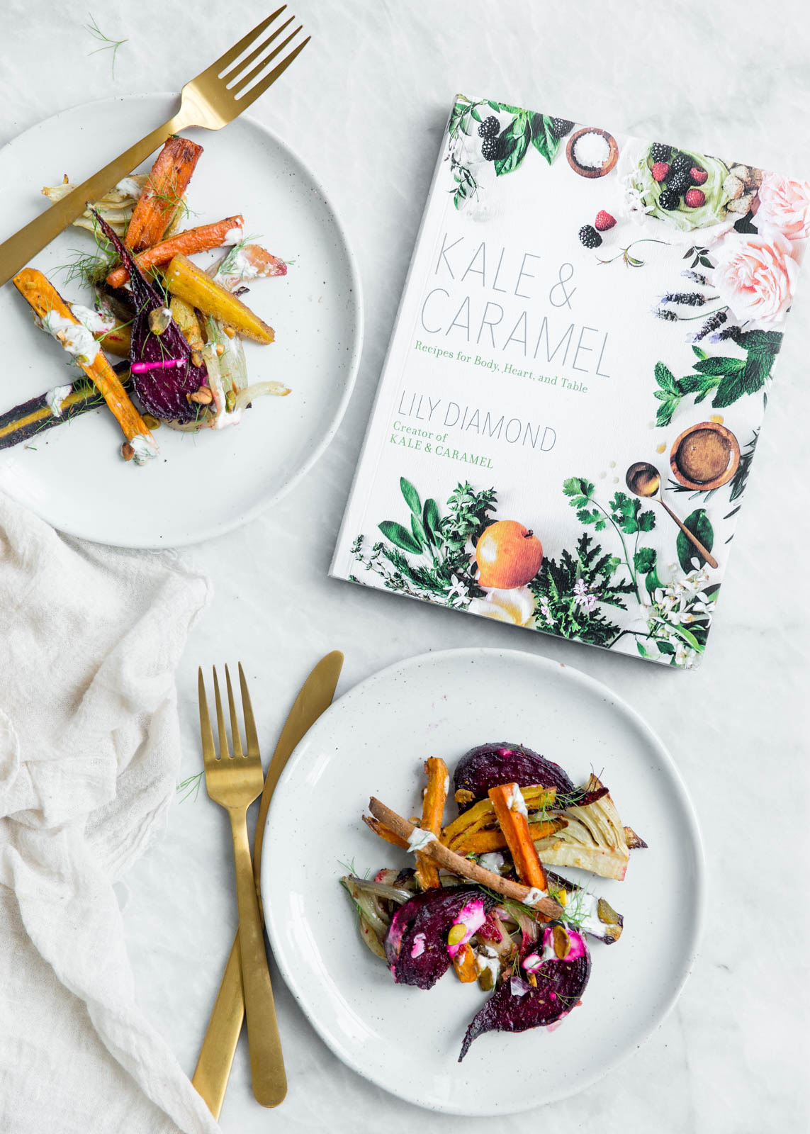 Perfectly caramelized Roasted Root Vegetables tossed in fennel and cumin and drizzled with pistachio yogurt and fennel fronds.