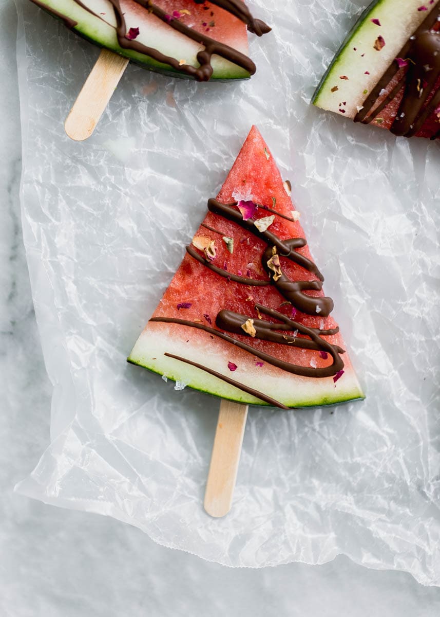 Low in sugar and totally refreshing, these fresh watermelon popsicles drizzled with chocolate and sea salt are the perfect treat on a hot summer's day! 
