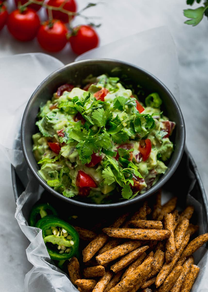 Secret ingredient alert! This Ultimate Skinny Guacamole is lighter and healthier, yet just as creamy and delicious. You'll never eat "regular" guac again!