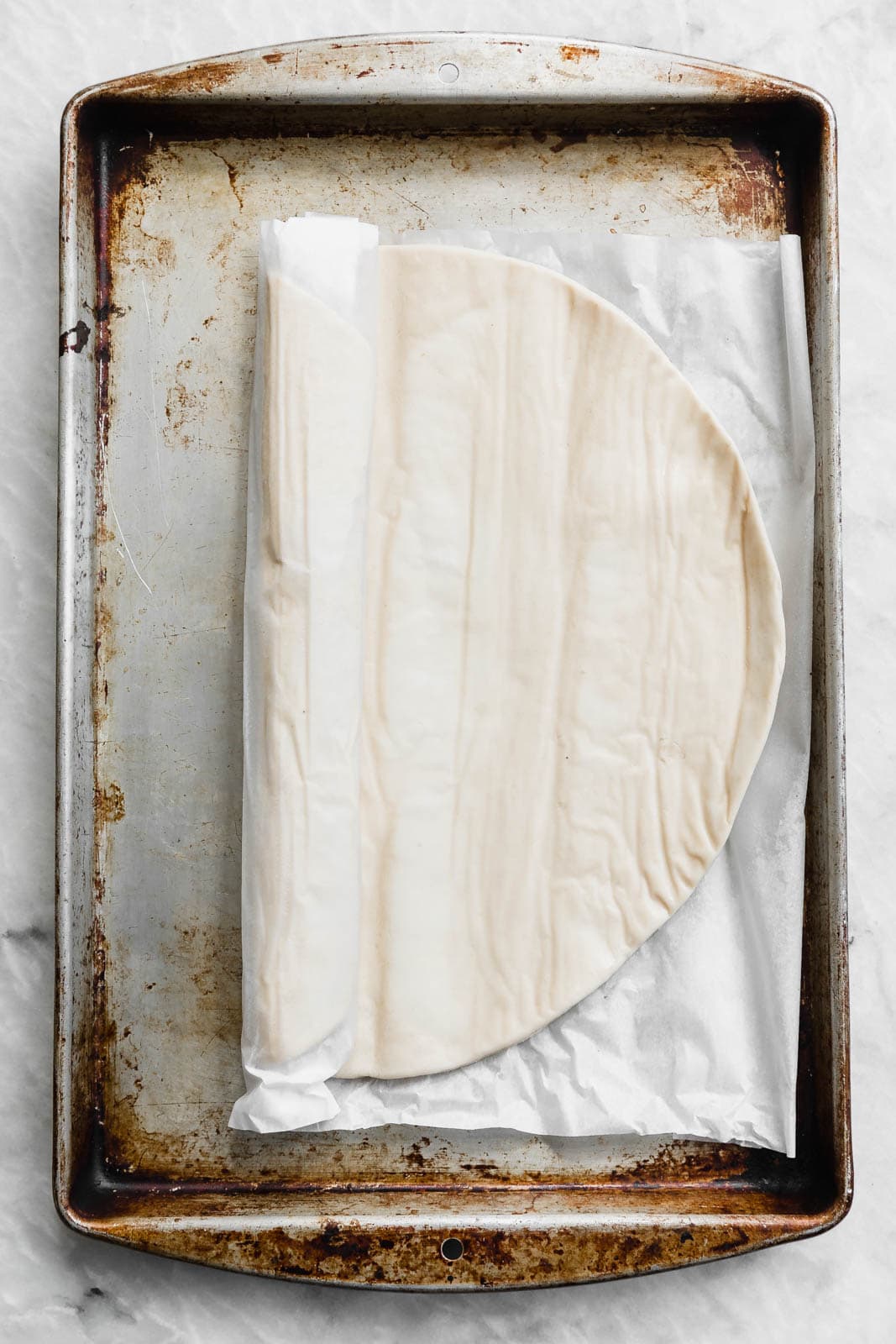 pizza dough on a baking sheet