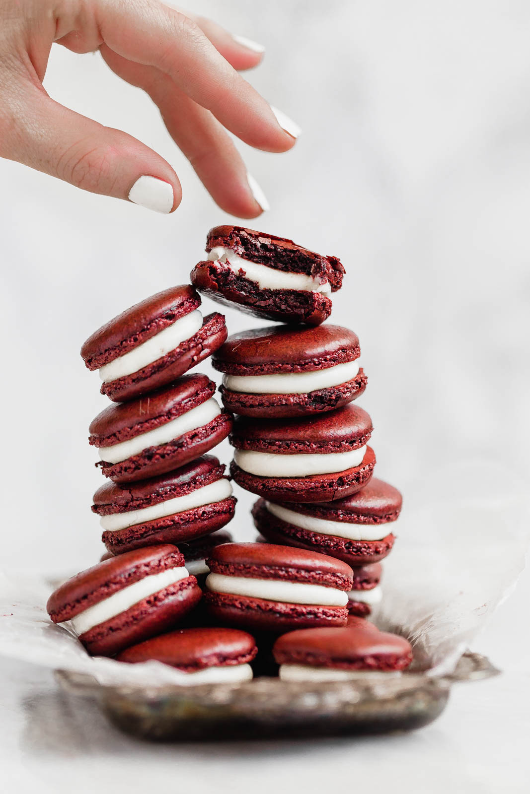 Decadent Red Velvet Macarons with a cream cheese frosting. Perfect for the holiday season, or just because!