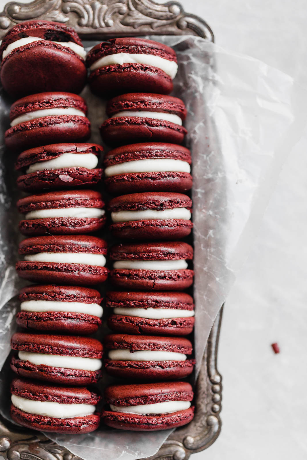 Decadent Red Velvet Macarons with a cream cheese frosting. Perfect for the holiday season, or just because!