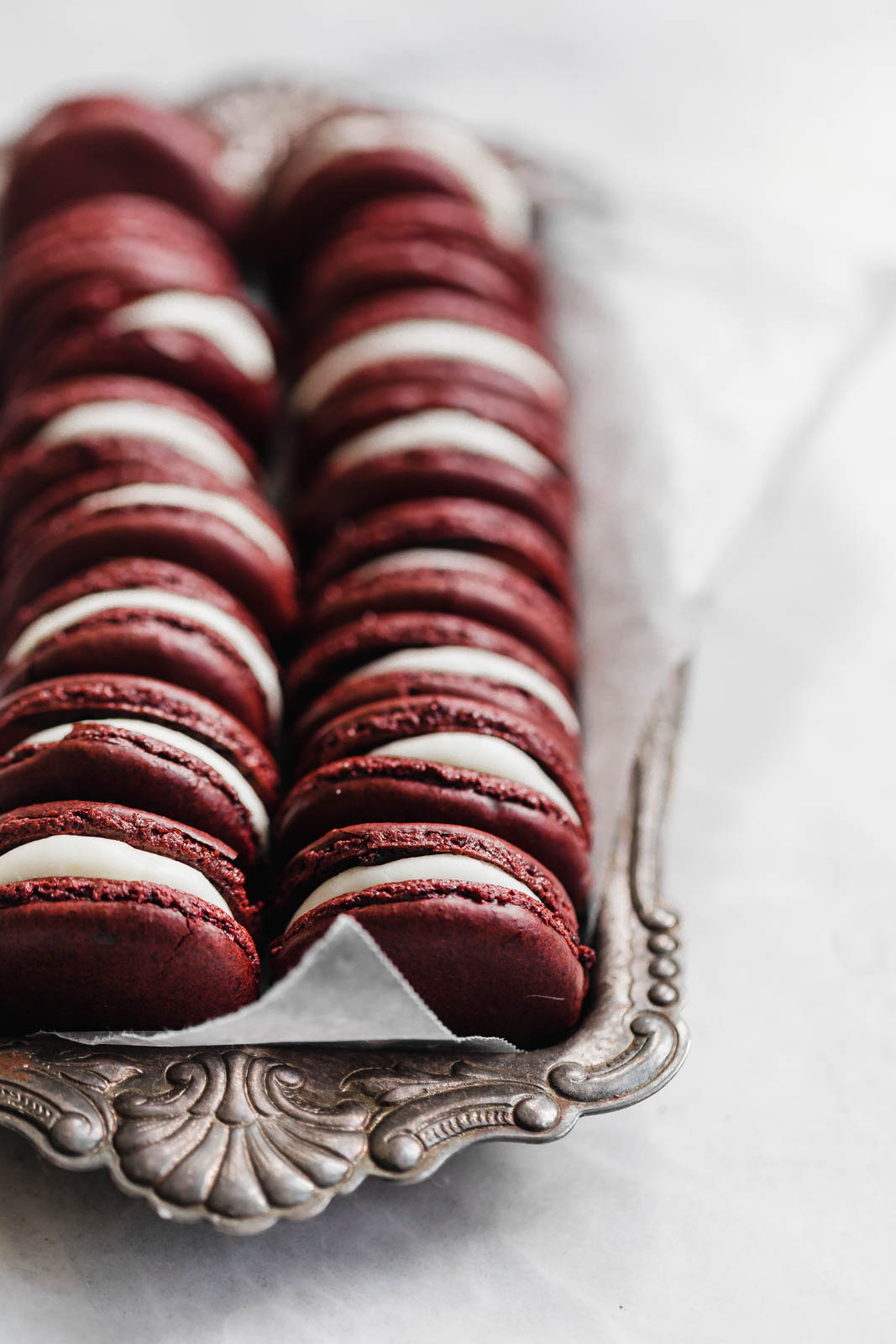 Decadent Red Velvet Macarons with a cream cheese frosting. Perfect for the holiday season, or just because!