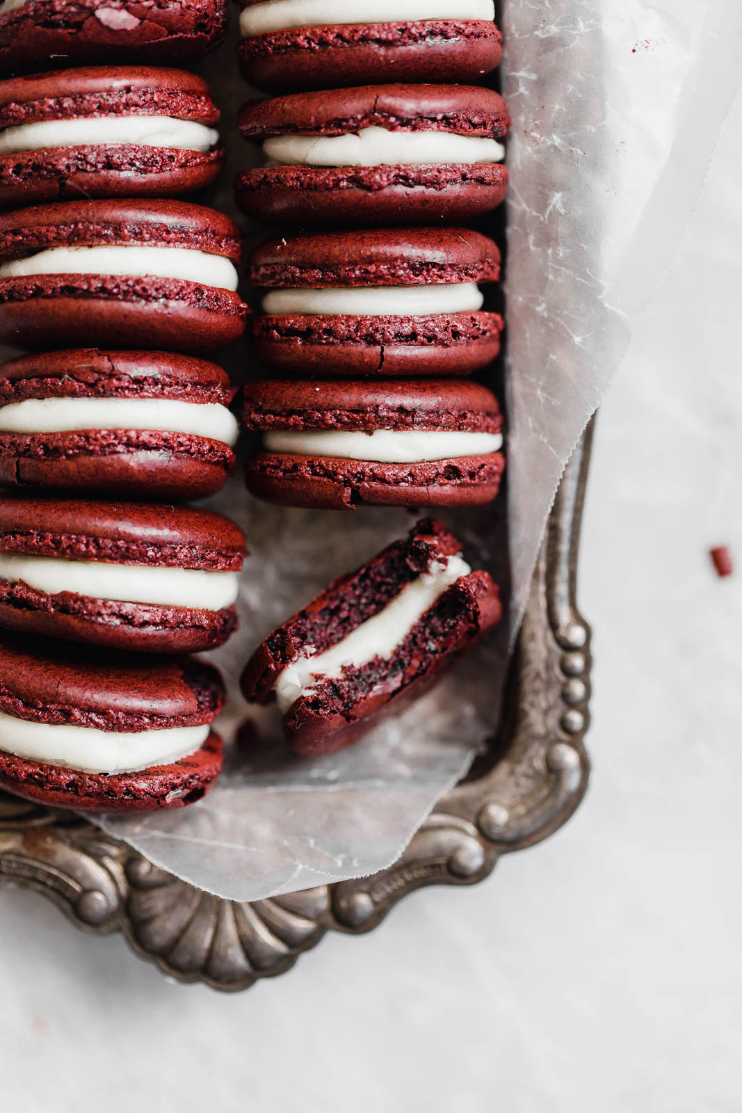 Decadent Red Velvet Macarons with a cream cheese frosting. Perfect for the holiday season, or just because!